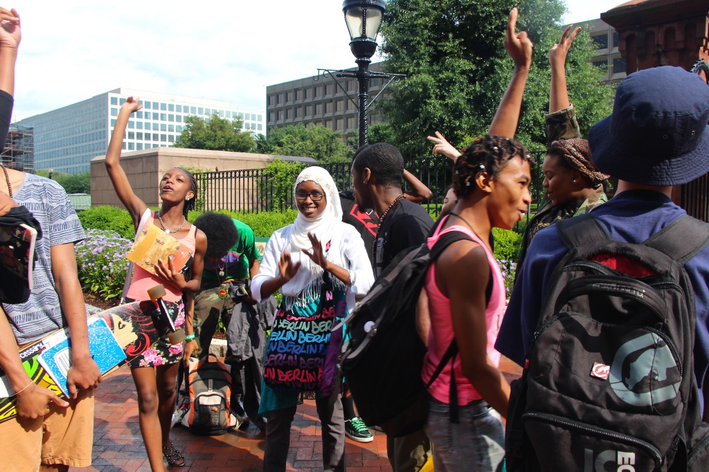 After a successful meeting at the Smithsonian African Art Museum on the National Mall, students of the DC Youth Slam Team celebrate outside with an impromptu dance party and freestyle cypher. The DC Youth Slam Team brings together teenage poets across lines of race, religion, socioeconomic status, and sexuality to use spoken word poetry to raise and challenge issues of social justice and build peace (July 2013).