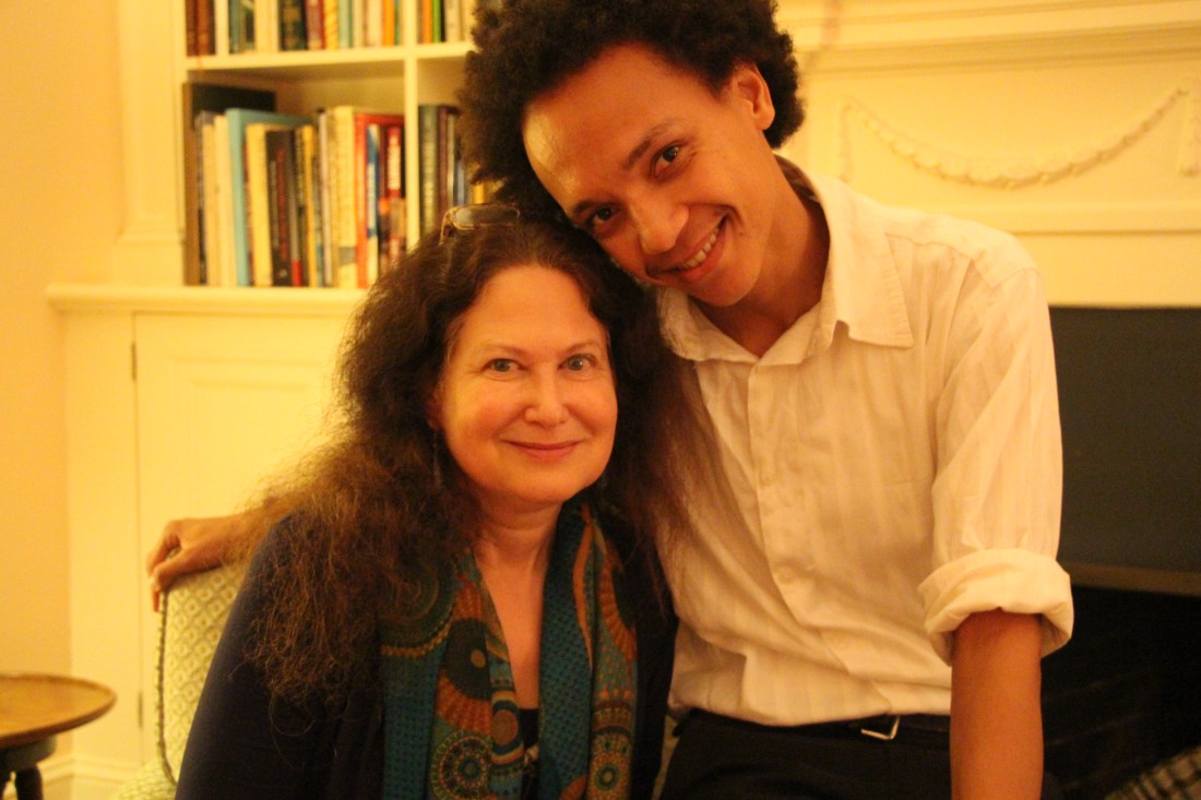 Clear and Jane Hirshfield posing for a picture. she is seated and he is leaning on the arm of the seat with his arm around her.